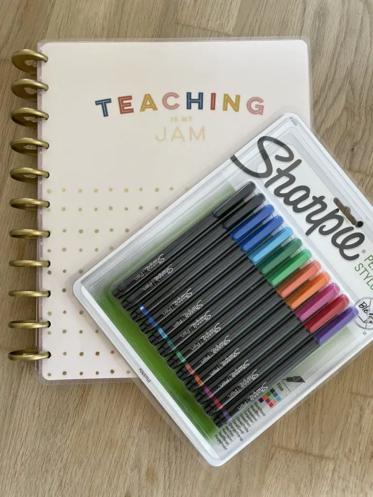 Image of Katie's Teacher planner and multicolour Sharpie pens. The planner says "Teaching is my jam" on the front.